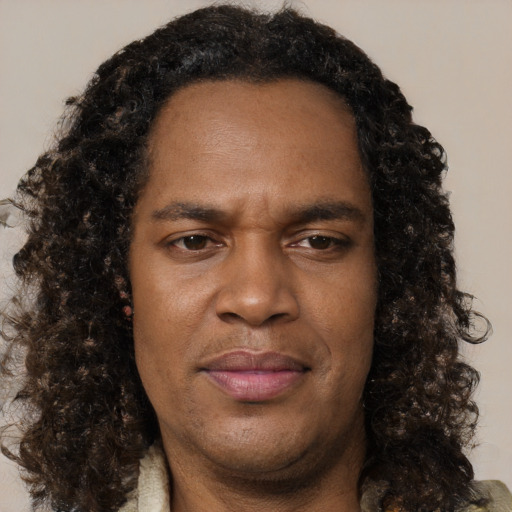 Joyful black young-adult male with medium  brown hair and brown eyes