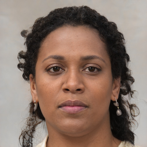 Neutral black young-adult female with long  brown hair and brown eyes