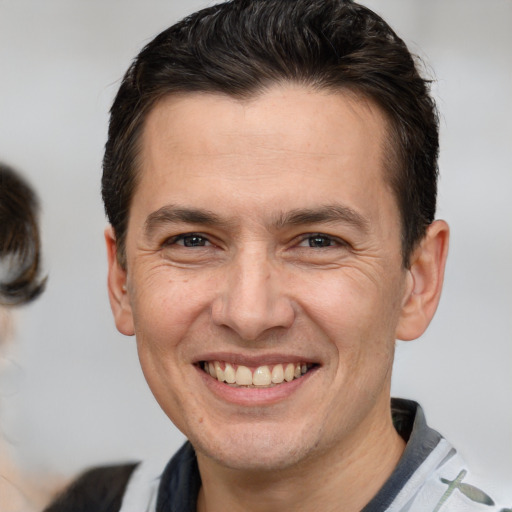 Joyful white adult male with short  brown hair and brown eyes