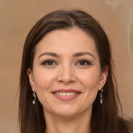 Joyful white young-adult female with long  brown hair and brown eyes