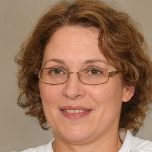 Joyful white middle-aged female with medium  brown hair and blue eyes