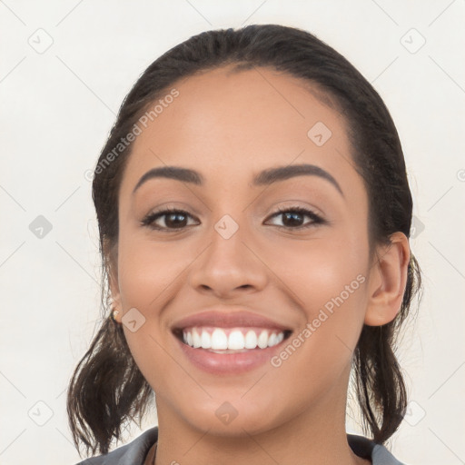 Joyful white young-adult female with long  brown hair and brown eyes