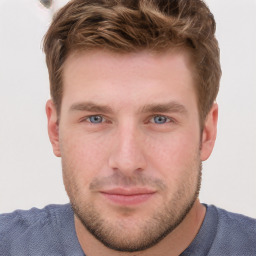 Joyful white young-adult male with short  brown hair and blue eyes