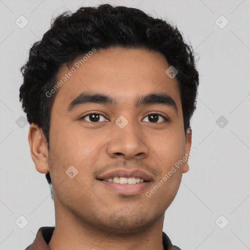 Joyful latino young-adult male with short  black hair and brown eyes