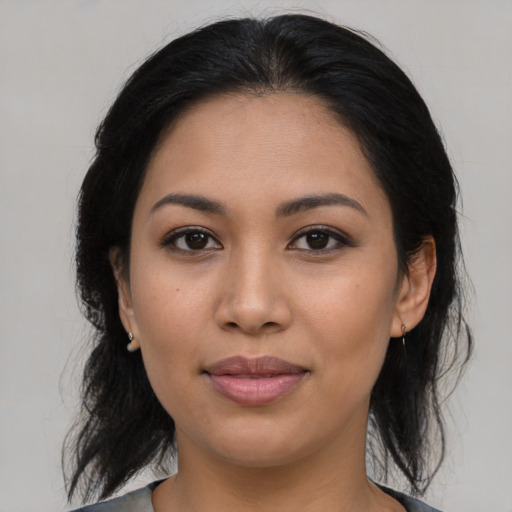 Joyful latino young-adult female with medium  brown hair and brown eyes