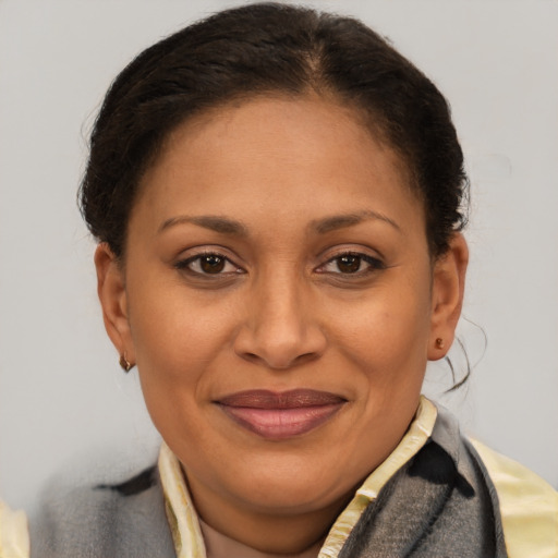 Joyful latino adult female with short  brown hair and brown eyes