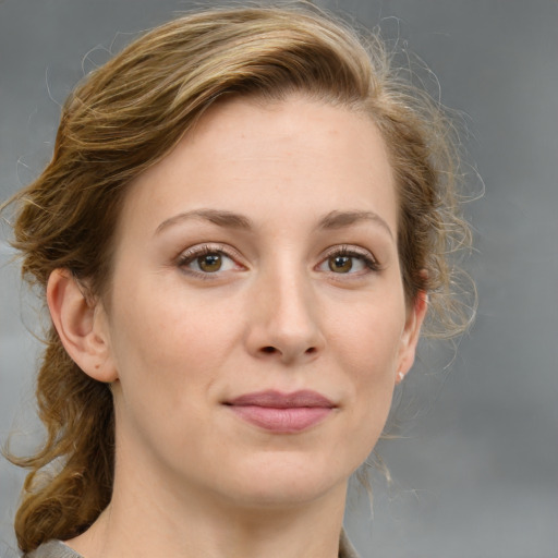 Joyful white young-adult female with medium  brown hair and green eyes