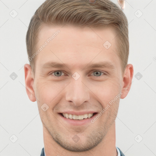 Joyful white young-adult male with short  brown hair and grey eyes