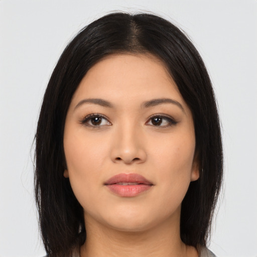 Joyful asian young-adult female with long  brown hair and brown eyes