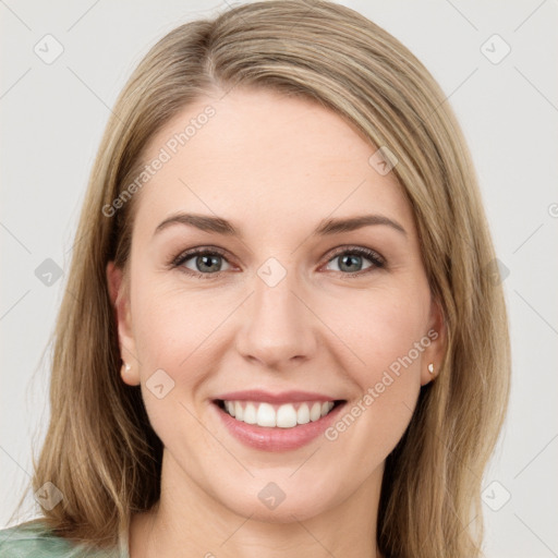 Joyful white young-adult female with long  brown hair and green eyes