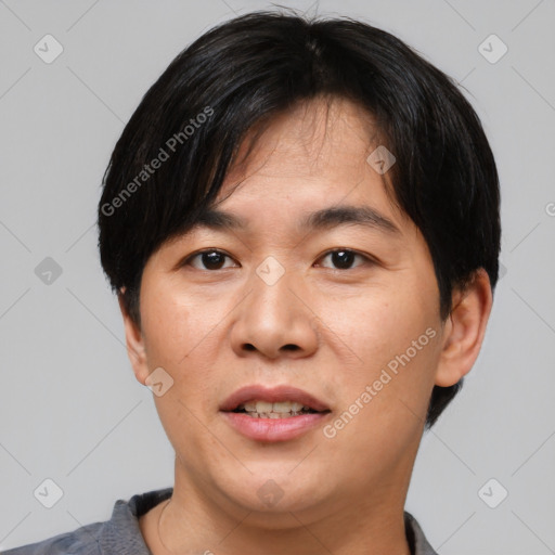 Joyful asian young-adult male with short  black hair and brown eyes