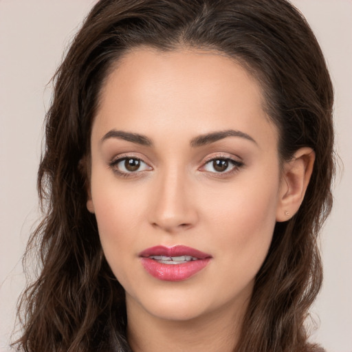 Joyful white young-adult female with long  brown hair and brown eyes