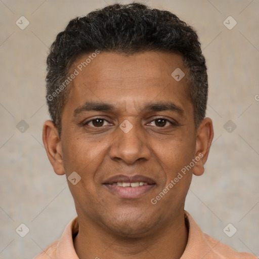 Joyful black young-adult male with short  brown hair and brown eyes