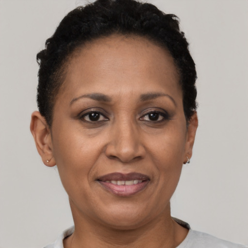 Joyful latino adult female with short  black hair and brown eyes