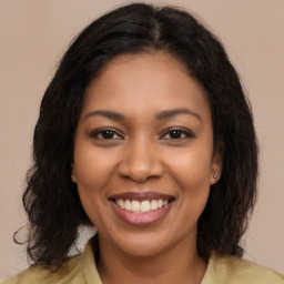 Joyful black young-adult female with medium  brown hair and brown eyes