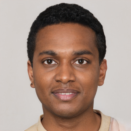 Joyful black young-adult male with short  black hair and brown eyes