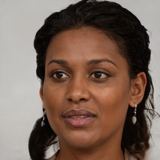 Joyful black young-adult female with medium  brown hair and brown eyes