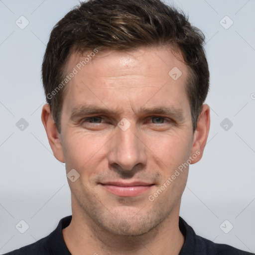 Joyful white adult male with short  brown hair and brown eyes