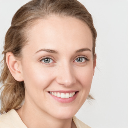 Joyful white young-adult female with medium  brown hair and blue eyes