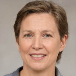 Joyful white adult female with medium  brown hair and grey eyes