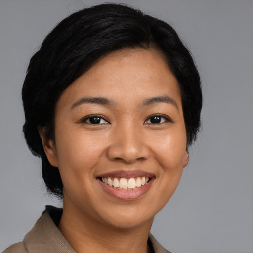 Joyful asian young-adult female with short  black hair and brown eyes