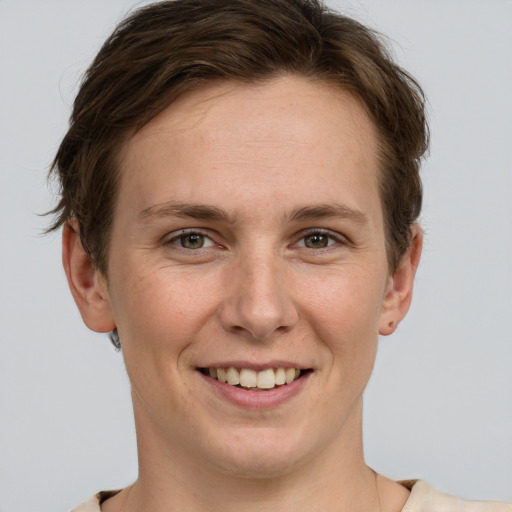 Joyful white young-adult female with short  brown hair and grey eyes