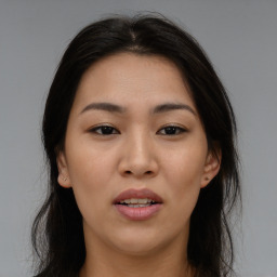 Joyful asian young-adult female with long  brown hair and brown eyes