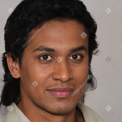 Joyful black young-adult male with short  brown hair and brown eyes