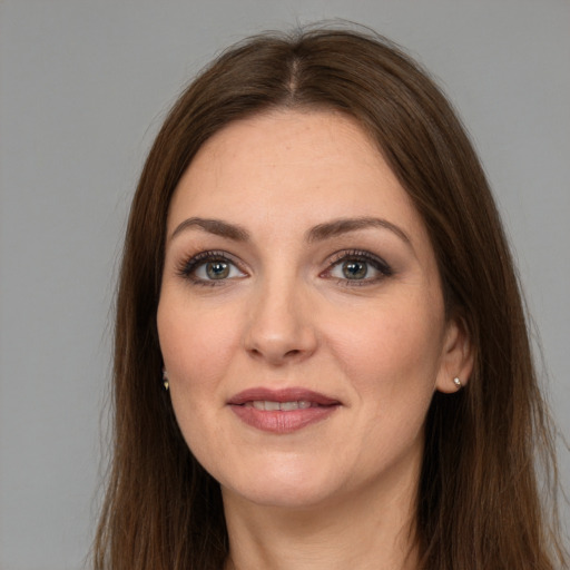 Joyful white young-adult female with long  brown hair and grey eyes