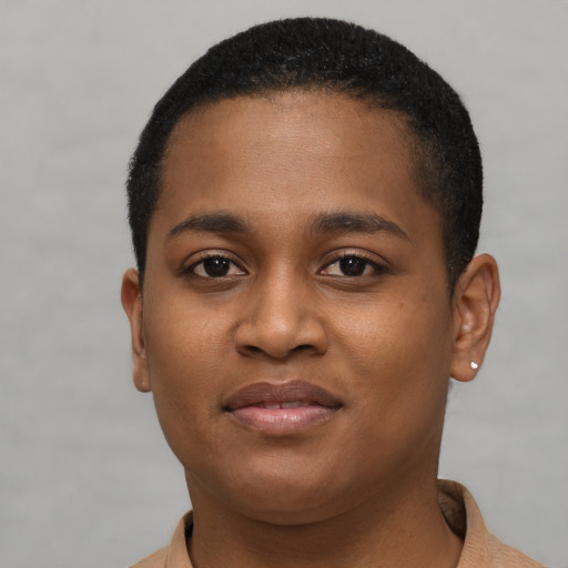 Joyful black young-adult female with short  brown hair and brown eyes