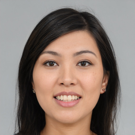 Joyful latino young-adult female with long  black hair and brown eyes