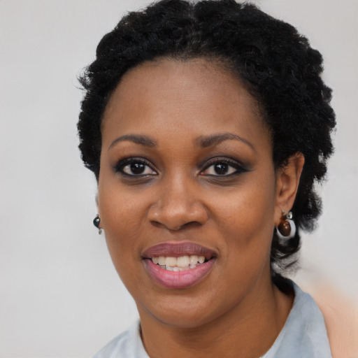 Joyful black young-adult female with short  black hair and brown eyes