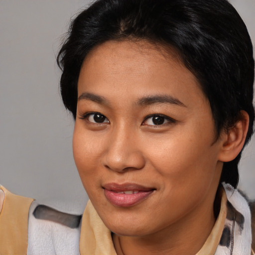 Joyful asian young-adult female with medium  brown hair and brown eyes