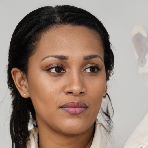 Joyful black young-adult female with medium  brown hair and brown eyes