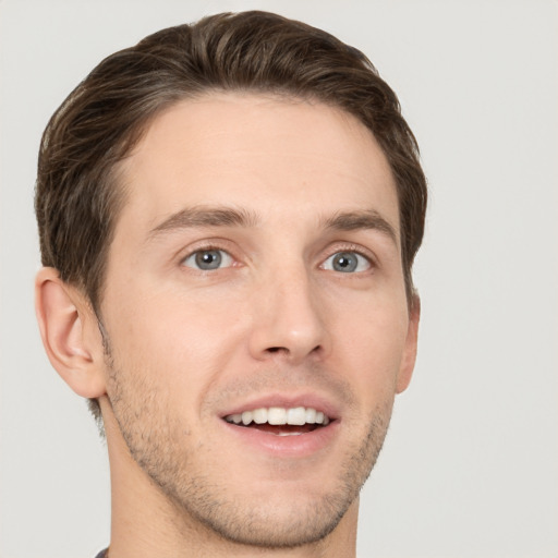 Joyful white young-adult male with short  brown hair and grey eyes