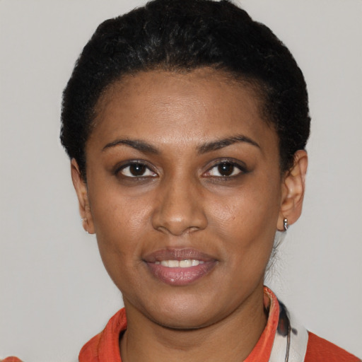 Joyful latino young-adult female with short  black hair and brown eyes