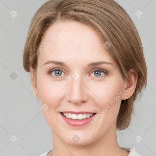 Joyful white young-adult female with medium  brown hair and green eyes