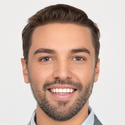 Joyful white young-adult male with short  black hair and brown eyes