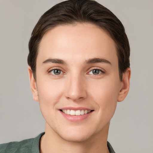 Joyful white young-adult female with short  brown hair and grey eyes