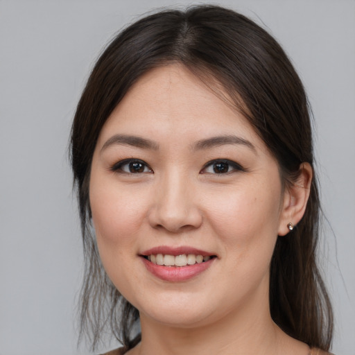 Joyful white young-adult female with medium  brown hair and brown eyes
