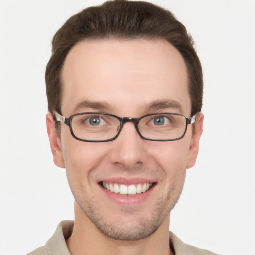 Joyful white young-adult male with short  brown hair and grey eyes