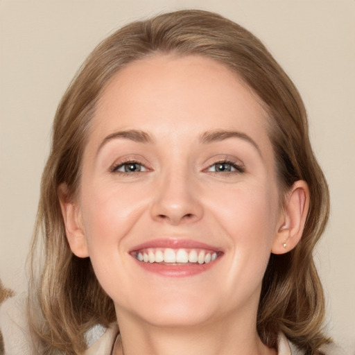 Joyful white young-adult female with medium  brown hair and blue eyes