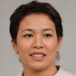 Joyful asian adult female with short  brown hair and brown eyes