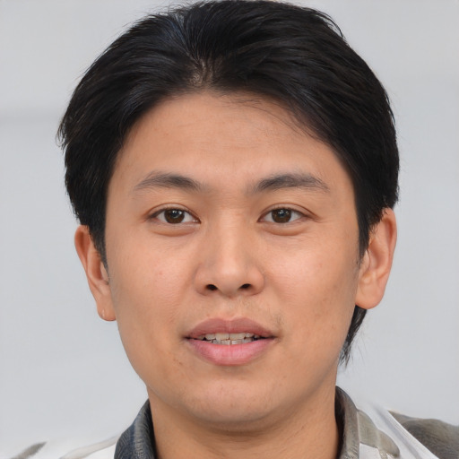 Joyful asian young-adult male with short  brown hair and brown eyes