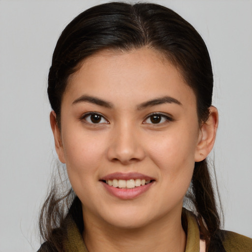 Joyful latino young-adult female with long  brown hair and brown eyes