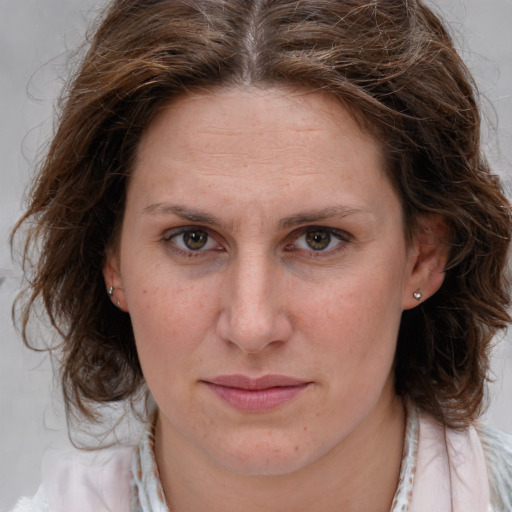 Joyful white young-adult female with medium  brown hair and blue eyes