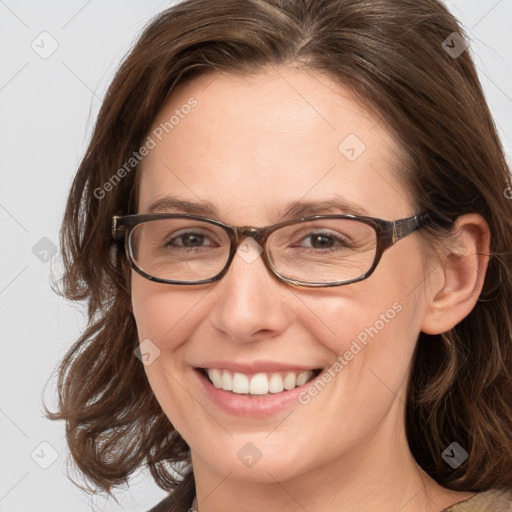 Joyful white adult female with medium  brown hair and blue eyes