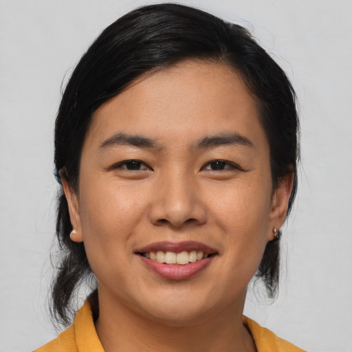 Joyful asian young-adult female with medium  black hair and brown eyes