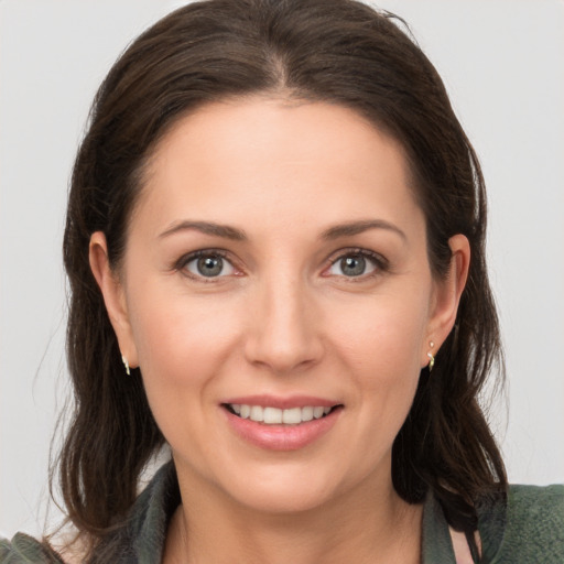 Joyful white young-adult female with medium  brown hair and brown eyes