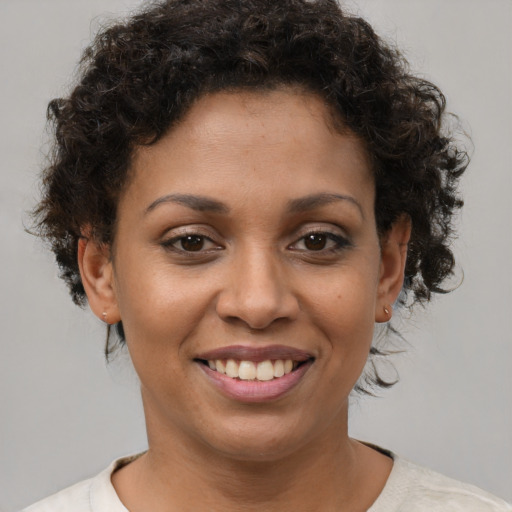 Joyful latino young-adult female with short  brown hair and brown eyes